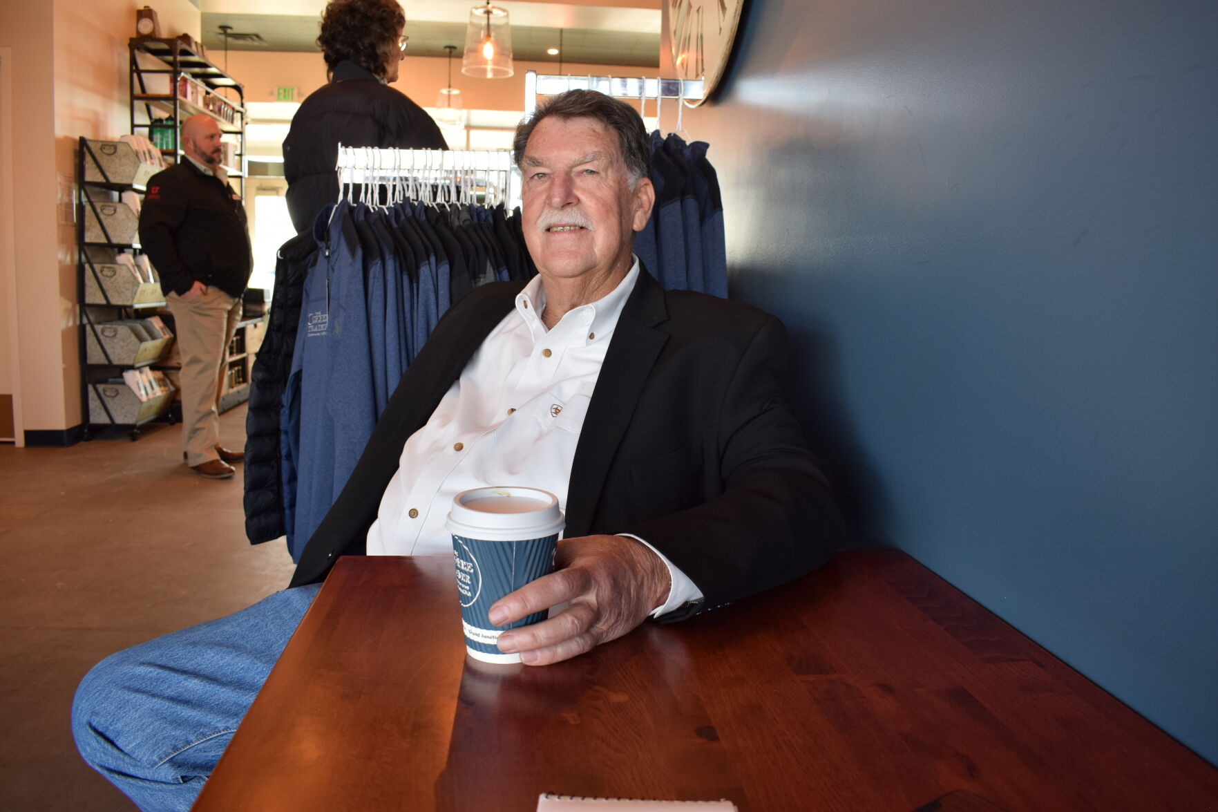 Coram with coffee cup sitting